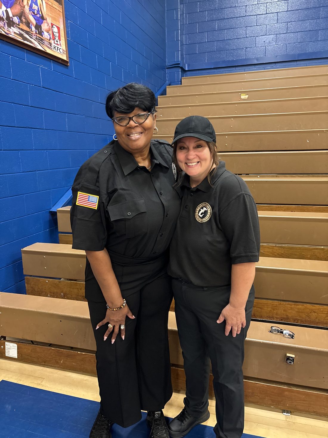 Two Tiburo Security officers on assignment at a school gymnasium event
